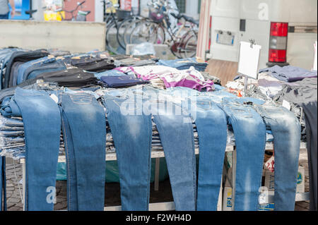 Jeans on display for sale at the local market. Northern Italy Stock Photo