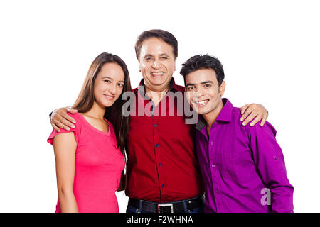 3 indian father and young son and daughter standing Stock Photo