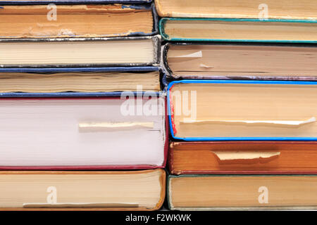 A stack of old books with bookmarks in different directions on different pages. Stock Photo