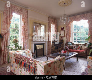 Indian throw on a floral sofa in a nineties country living room with Toile-de-Jouy curtains on the windows Stock Photo