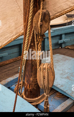 Rope in wooden pulleys / blocks on deck of sailing boat / fishing boat Stock Photo