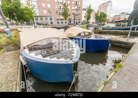 Solar powered electric boats on a canal in Amsterdam Stock Photo