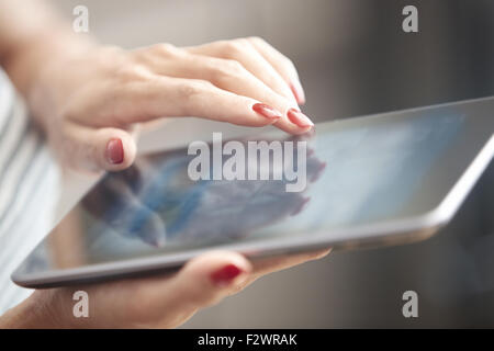 Hands of woman using digital tablet Stock Photo