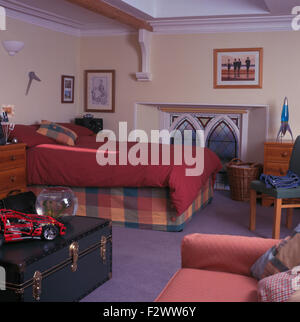 Dark Red Duvet On Bed Beside Top Of Gothic Window In