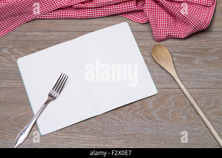 Image shows an open booklet with pen and rolling pin on a table Stock Photo