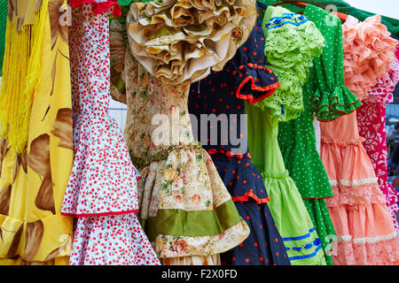 Andalusian gipsy dresses in a row at Spain outdoor market Stock Photo