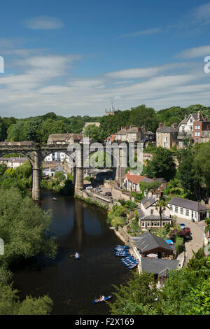Blue sky above Knaresborough, England, UK - scenic sunny summer view of viaduct bridge over River Nidd, boats, steep wooded gorge & riverside houses. Stock Photo