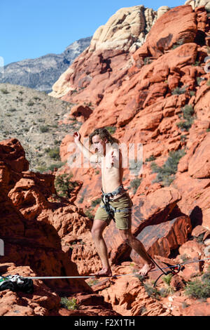 Man walks on highline at Red Rock Canyon National Conservation Area, which is about 20 miles from   Las Vegas Stock Photo