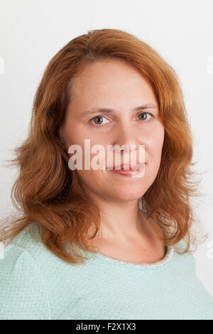 Young Caucasian woman, closeup studio portrait on light gray background Stock Photo