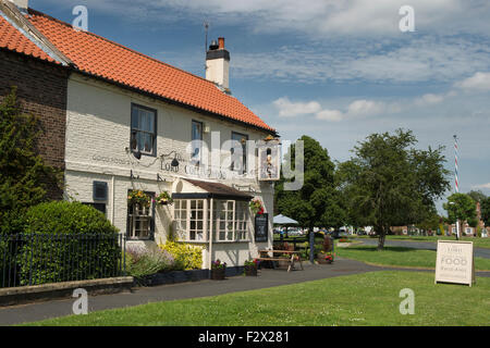 Sunny summer view of attractive, traditional, old, English rural pub (The Lord Collingwood) - Upper Poppleton village green,  near York, England, UK. Stock Photo