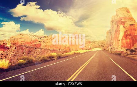 Retro vintage style mountain road at sunset, travel adventure concept, USA.