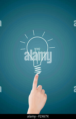 1 Business woman Drawing Bulb touching Digitally Enhanced Stock Photo