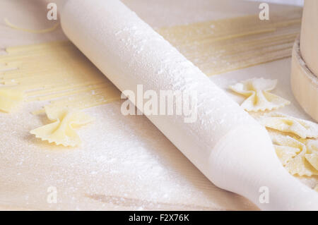 Rolling pin for cooking pasta dough on the table Stock Photo
