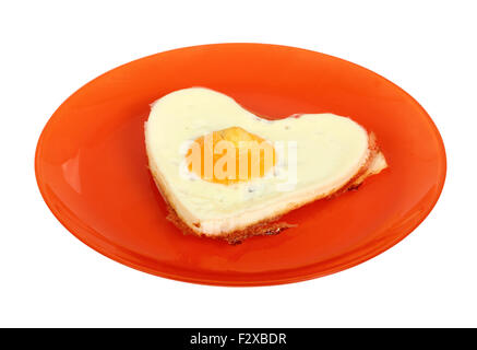 Fried Egg Sunny Side Up in Heart Shape. Isolated with clipping path. Stock Photo