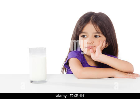 1 indian Kid girl Drinking Milk Thinking Stock Photo