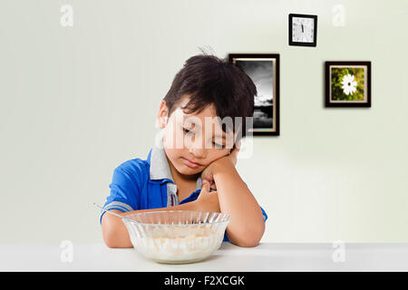 1 indian Kid boy Breakfast Eating Corn Flakes Thinking Stock Photo