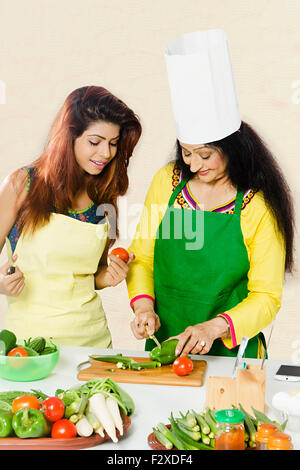 2 indian Adult Woman mother and daughter Kitchen Cooking Stock Photo