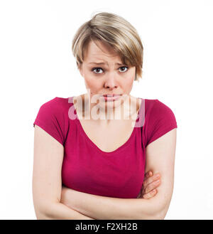 young woman appearing to be in an uncomfortable attitude, isolated on white Stock Photo