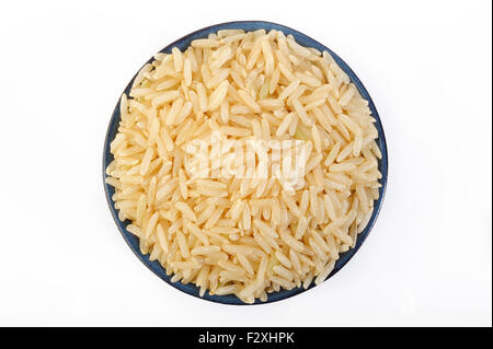 Brown rice in bowl Stock Photo