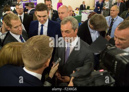 Doncaster, South Yorkshire, UK. 25th September, 2015. Nigel Farage is mobbed by journalists at the UKIP National Conference in Doncaster South Yorkshire, UK. 25th September 2015. UKIP leader Farage today declared that he is to put the EU referendum battle before his party priorities. Credit:  Ian Hinchliffe/Alamy Live News Stock Photo