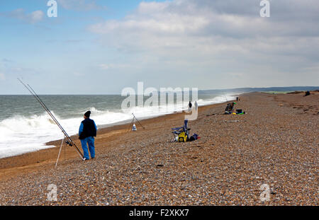 Sea anglers fishing from the beach at Cley Next the Sea, Norfolk, England, United Kingdom. Stock Photo