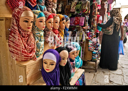 Mannequins wearing hijab/alamira headscarfs outside shop in Fez medina, Morocco Stock Photo