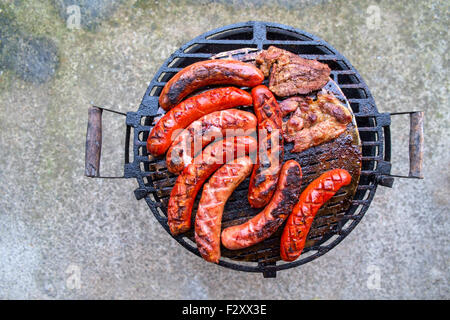 Grilling sausages on barbecue grill. Stock Photo