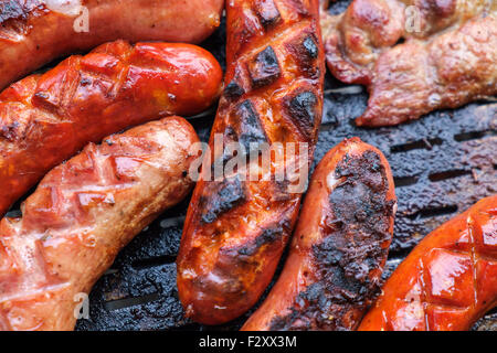 Grilling sausages on barbecue grill. Selective focus. Stock Photo