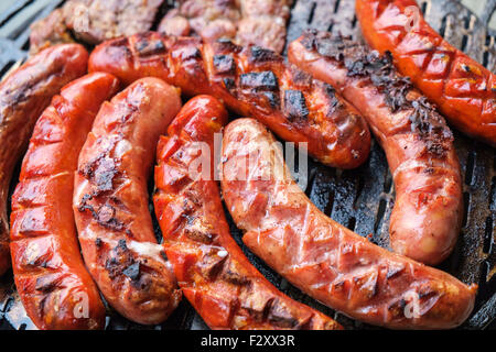 Grilling sausages on barbecue grill. Selective focus. Stock Photo