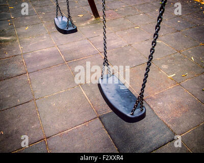 Empty chain swing in playground in city Stock Photo