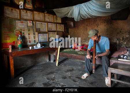 man smoking opium in Vietnam Stock Photo