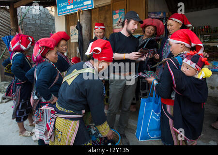 'Red Dzao' of the ethnic Hmong tribe selling souvenirs to tourists Stock Photo