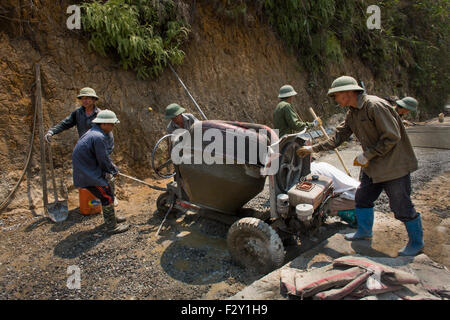 Vietnamese road workers building a new road Stock Photo