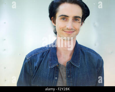 A young man wearing a denim shirt and hat. Stock Photo