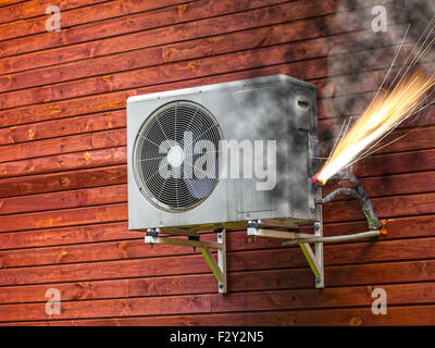 Overloaded electrical circuit causing electrical short and fire. Stock Photo