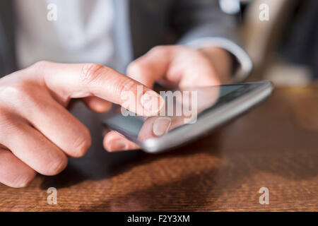 Close-up hands man using cell phone Stock Photo