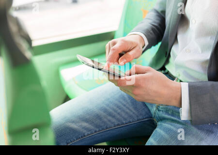 On bus man using his cell phone. Reading emails. texting  message. Close-up hands Stock Photo