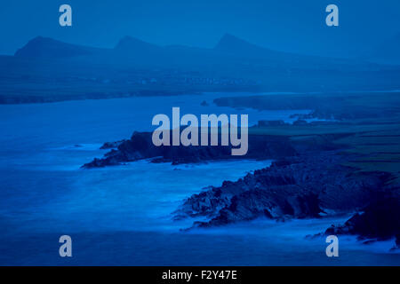 Pre-dawn view over Ballyferriter Bay, Sybil Point and the peaks of the Three Sisters, Dingle Peninsula, County Kerry, Ireland. Stock Photo