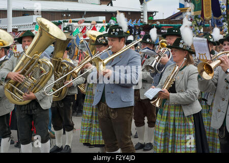 MUNICH, GERMANY – SEPT. 20, 2015: Traditional Marching Bands with Local Costumes entertain Crowds of visitors at the annual Oktoberfest. The Festival runs from September 19th until October 4th 2015 in Munich, Germany