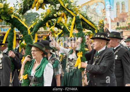 MUNICH, GERMANY – SEPT. 20, 2015: Traditional Marching Group with Local Costumes entertain Crowds of visitors at the annual Oktoberfest. The Festival runs from September 19th until October 4th 2015 in Munich, Germany.