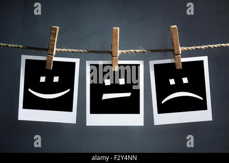 Happy, sad and neutral emoticons on instant print photographs Stock Photo