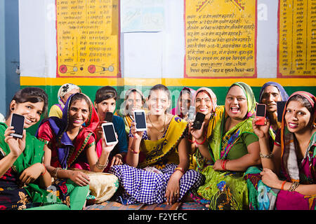 indian rural Villager group crowds womans Quality Mobile Phone showing Stock Photo