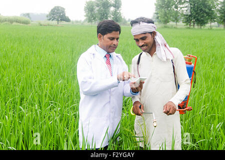 2 indian Doctor and rural farmer Farm Plants  Spraying Stock Photo