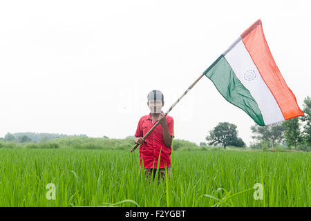 1 indian rural boy kids farm standing flag Independence Day Stock Photo