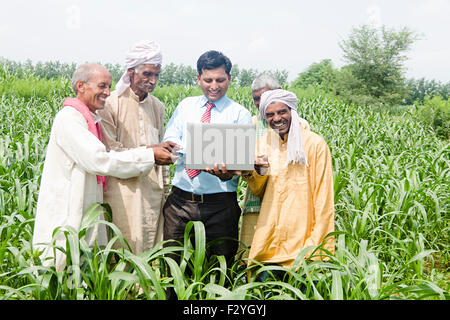 4 indian Business Man and rural farmer farm laptop working Stock Photo