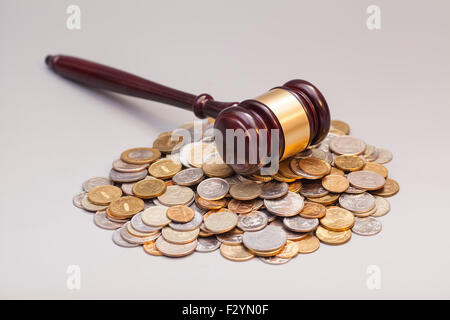 judges law gavel on pile of coins isolated on gray Stock Photo