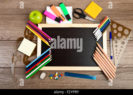 School supplies on blackboard background ready for your design Stock Photo