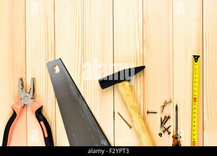 Assorted work tools on wooden background Stock Photo