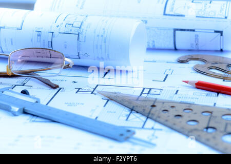 Architectural blueprints rolls and engineering items. Toned in blue Stock Photo