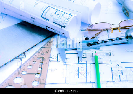 Architectural blueprints rolls and engineering items. Toned in blue Stock Photo